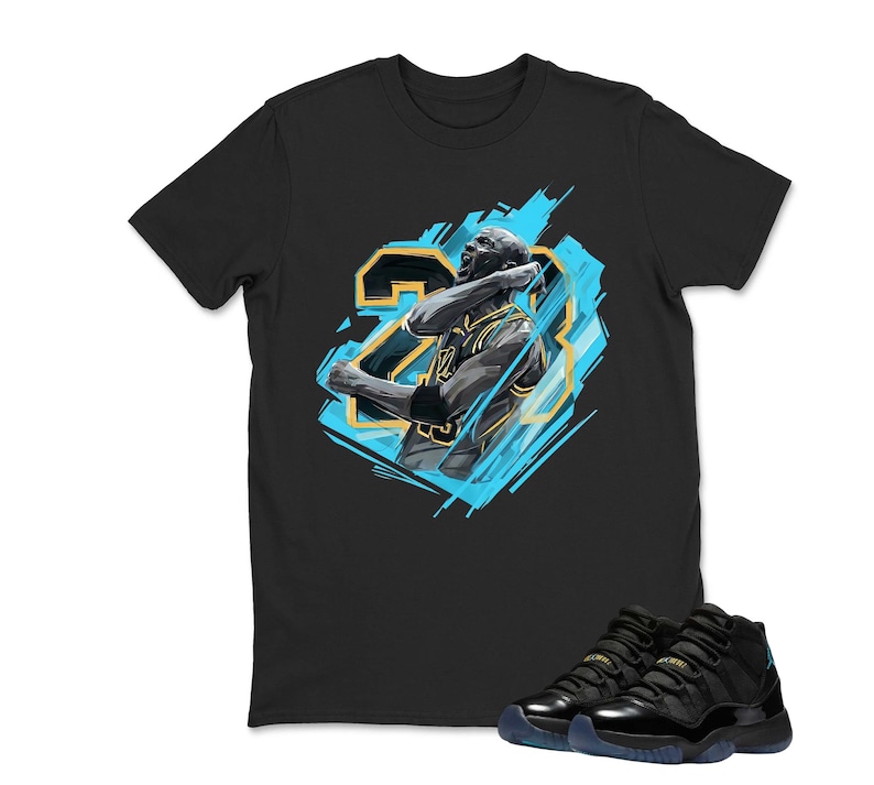 May include: Black t-shirt featuring a graphic of a basketball player in a blue and gold design, with the number 23. A pair of black and blue sneakers are at the bottom of the image.