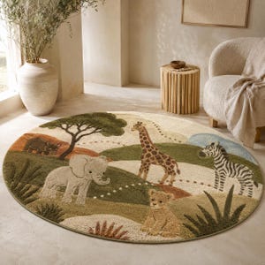Round wool area rug hand-tufted with a safari scene of giraffes, zebras, an elephant, and acacia trees on a green and tan landscape.