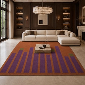 May include: A rectangular area rug featuring a burnt orange base color with a series of vertical purple stripes of varying heights. The rug includes small green rectangular accents at the top of some purple stripes, creating a graphic pattern.