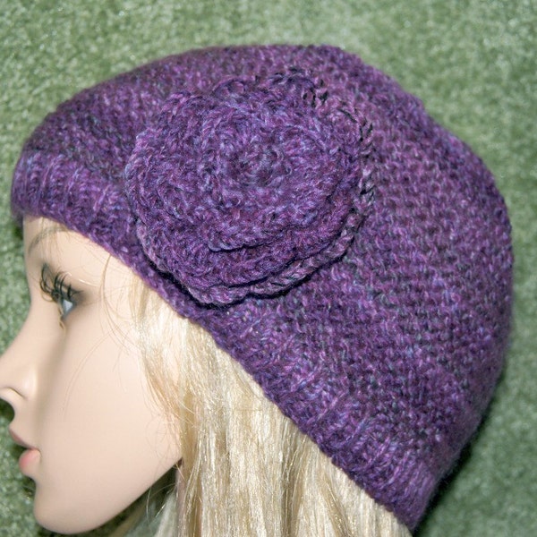 Really cute flower knit hat multi shades or purple . Very soft and fun to wear