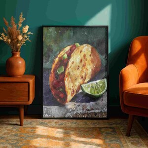 May include: Oil painting of a taco with a lime wedge. The taco is filled with red ingredients and topped with green diced vegetables. The painting is in a black frame and is displayed on a wall.