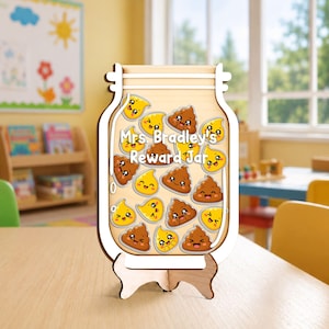 May include: A wooden reward jar shaped like a mason jar with a white frame and a light wood interior. The jar contains multiple small, colorful, smiling cartoon icons of brown piles and yellow droplets. The text Mrs. Bradley's Reward Jar is printed.
