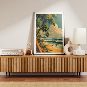 May include: A framed art print depicts a tropical beach scene with palm trees, surfers, and ocean waves. The artwork is displayed on a wooden cabinet with a lamp, vase, and stereo. The color palette includes blues, greens, and yellows.