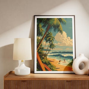 May include: Framed art print depicting a tropical beach scene with palm trees, surfers, and ocean waves. The artwork features a retro style with a color palette of blues, greens, and yellows. The print is displayed on a wooden cabinet with a lamp and vase.