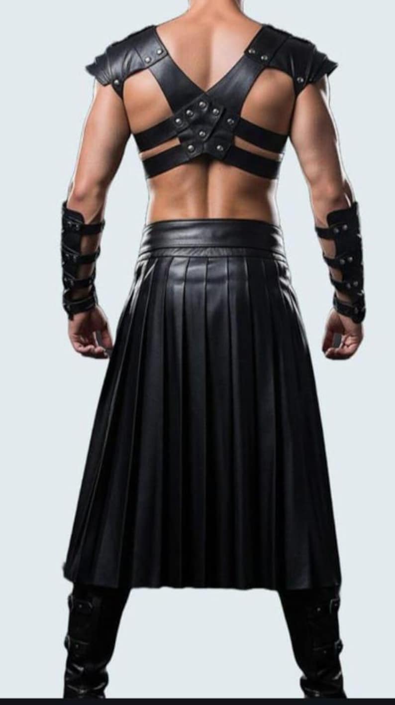 May include: Black leather kilt with matching shoulder and arm armor. The kilt is pleated and reaches the knees. The shoulder armor has studded accents. The arm armor is also black leather with studded details.