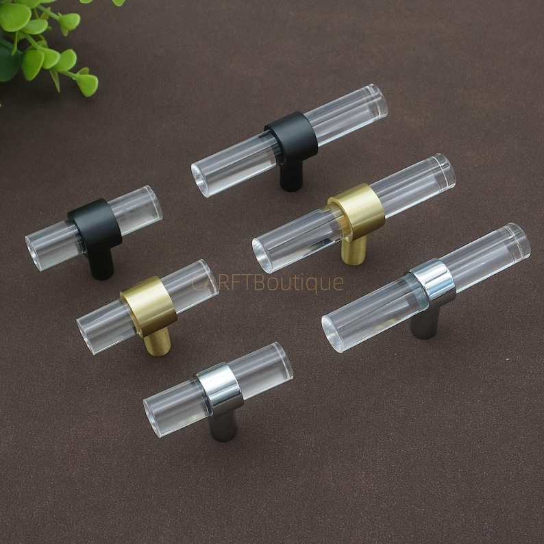 May include: A white ceramic mug with a black handle and the text "But First, Coffee" in a black, bold font. The mug is on a white surface.