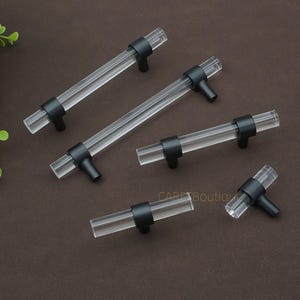 May include: A set of three ceramic mugs with a speckled, matte finish in cream, light grey, and dark grey. Each mug has a simple, minimalist design, ideal for coffee or tea.