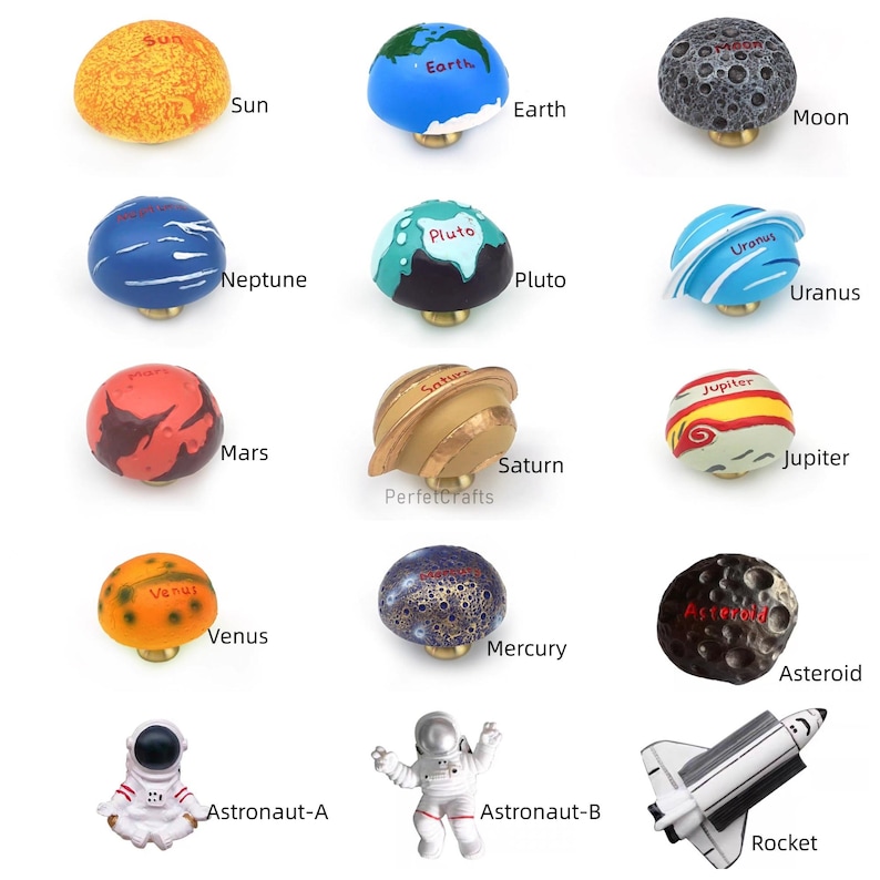 May include: A collection of decorative cabinet knobs and figurines, including planets like Earth, Mars, and Saturn, along with an astronaut and a rocket. The knobs are painted in vibrant colors and labeled with their respective names.