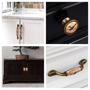 May include: A collection of decorative cabinet hardware featuring ceramic and metal designs. The hardware includes knobs and pulls with bird and floral motifs, in shades of gold, brown, and cream. The hardware is shown on white and black cabinets.