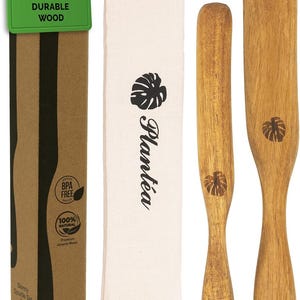 May include: A wooden spurtle set for sourdough baking. The set includes two spatulas and a smaller spurtle, along with a canvas bag and a cardboard box. The box has a green tag that says "Premium Durable Wood."