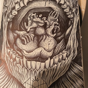 May include: A detailed pen and ink drawing of a monstrous mouth with sharp teeth. Inside, a grotesque form with hands reaching out is depicted. The artwork is dark and detailed, with a focus on texture and shadow, creating a surreal and unsettling image.