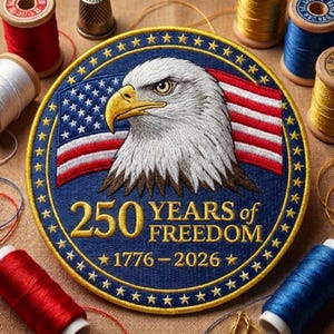 May include: Embroidered patch featuring an American bald eagle and the American flag. The patch is round, with the text "250 YEARS OF FREEDOM 1776-2026". The patch is surrounded by a gold border and stars. Sewing supplies are in the background.