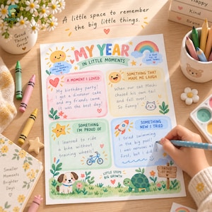 May include: A My Year in Little Moments activity sheet with colorful illustrations of a sun, rainbow, puppy, and turtle. The paper features sections for writing about memories, laughter, pride, and new experiences, surrounded by crayons and art supplies.
