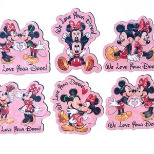 May include: A collection of six pink stickers featuring Mickey and Minnie Mouse in various romantic poses. Each sticker has the text "We Love Your Door!" in a handwritten style font. The characters are in their classic outfits.