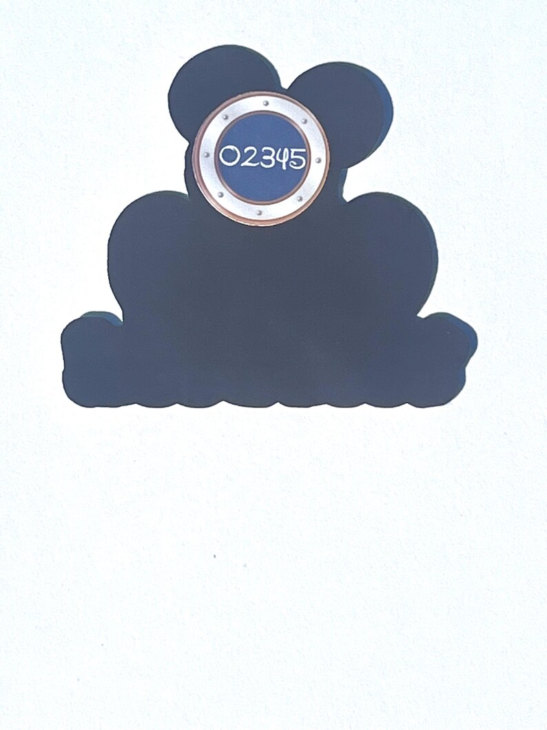 May include: A dark blue decorative sign shaped like Mickey Mouse's head. It features a circular element with the number "02345" in white. The sign is set against a white background.