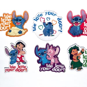 May include: A collection of colorful cartoon character stickers. The stickers feature the character Stitch, with the phrase "We love your door!" in various designs. The stickers are in shades of blue, pink, and green.