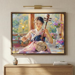 May include: A framed painting depicts a woman in traditional Korean attire playing a stringed instrument. The artwork features a warm color palette with floral accents and a wooden frame, creating a serene and cultural ambiance.