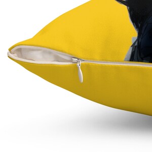 May include: A yellow throw pillow with a zipper closure. The pillow is made of a soft, comfortable fabric.