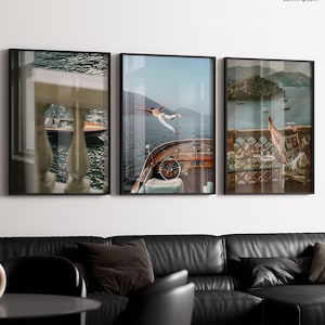 May include: Three framed art prints. The central print shows a person diving into the water from a wooden boat. The other two prints depict scenic views of water and buildings. The text "Lorem Ipsum" is in the upper right corner.