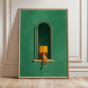 May include: A framed art print depicting a person reading a book in a green arched window. The person is seated on the window ledge, holding an open orange book. The artwork has a minimalist style with a wooden frame.