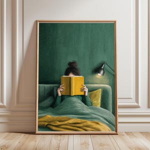 May include: A framed art print showing a person reading in bed. The person is covered with a green blanket and wearing a green sweater. A yellow book is held open, hiding the face. The background is a dark green wall.
