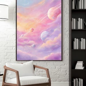 May include: A framed art print depicting a dreamy space scene. Pastel colors of pink, purple, and blue blend to create a celestial landscape with planets, clouds, and stars. The artwork is displayed above a wooden chair with a white cushion.