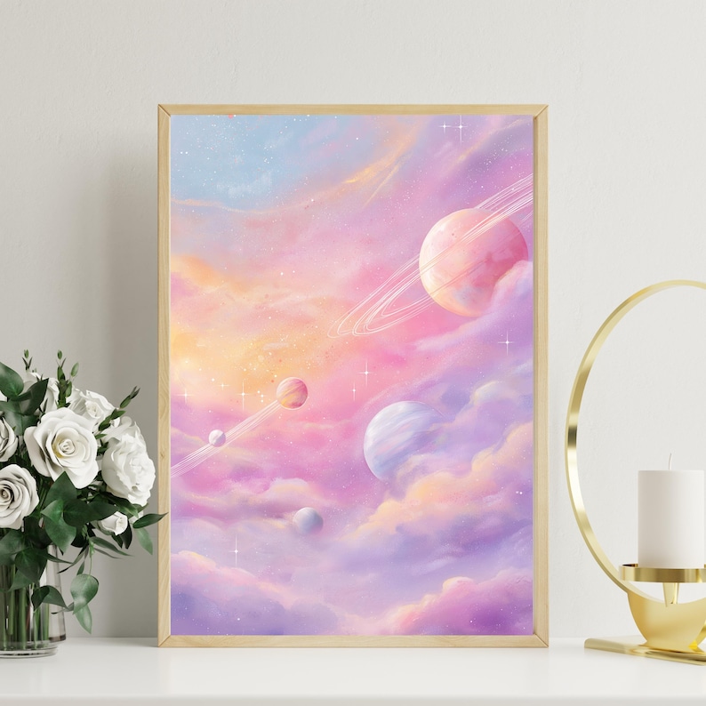 May include: A framed art print featuring a dreamy, pastel-colored space scene. The artwork depicts planets with rings, set against a backdrop of swirling clouds in shades of pink, purple, and orange. The print is in a gold frame.