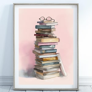 Op de afbeelding: Een ingelijste aquarelprint van een hoge stapel boeken in verschillende kleuren, met een ronde bril erop. De achtergrond is zachtroze en de lijst is lichtgrijs.