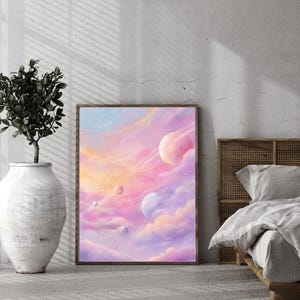 May include: A framed art print featuring a dreamy celestial scene. The artwork depicts planets with rings and clouds in shades of pink, purple, and orange. The print is leaning against a wall, next to a decorative vase and a bed.