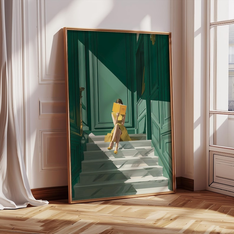 May include: A framed art print depicts a person in a yellow dress reading a book on a staircase. The artwork features a green door and walls, with a gold frame. The stairs are white and gray, and the overall style is elegant.