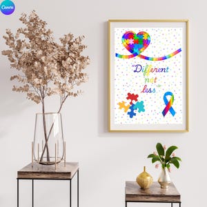 Könnte beinhalten: Ein gerahmter Druck mit goldenem Rahmen zeigt ein Herz aus Puzzleteilen und einem Regenbogenband. Der Text "Different not less" ist in bunten Buchstaben geschrieben. Ein blaues, rotes und gelbes Puzzleteil ist ebenfalls abgebildet.