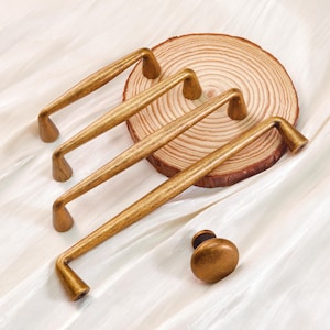 May include: A set of three ceramic mugs with a speckled, matte finish. The mugs are in shades of cream, light gray, and dark gray. Each mug has a simple, minimalist design, perfect for coffee or tea.