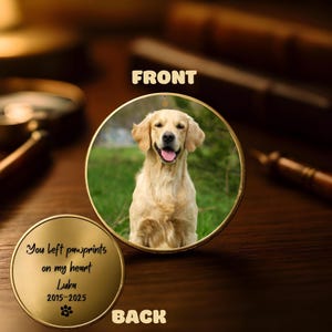 May include: A golden metal pet memorial ornament. The front features a photo of a golden retriever dog inside a gold frame. The back of the ornament has the text "You left pawprints on my heart Luka 2015-2025" with a paw print symbol.