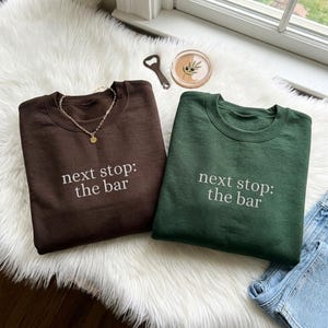 May include: A set of three ceramic mugs with a speckled, matte finish. The mugs are in shades of cream, light gray, and dark gray. Each mug has a simple, minimalist design, perfect for coffee or tea.