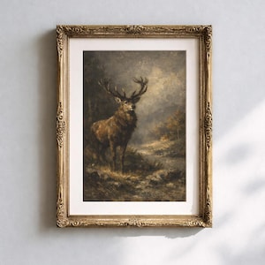 Op de afbeelding: Een ingelijste kunstdruk met een olieverfschilderij van een hert in een donker, mistig boslandschap. Het kunstwerk zit in een sierlijke, goudkleurige lijst in antieke stijl met gedetailleerd houtsnijwerk langs de randen en de hoeken.