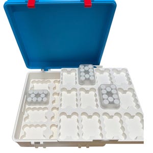 May include: A blue and white plastic storage case with a hinged lid and two red latches. The interior features a white tray with multiple scalloped compartments for organizing small items, including two clear containers holding small white circular caps.