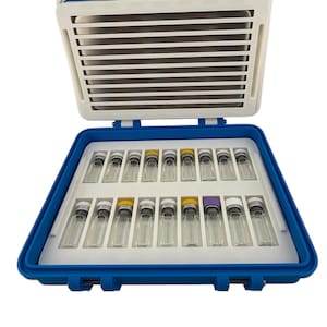 May include: A blue and white case with an open lid, revealing rows of small glass vials. The vials have silver, yellow, and purple caps. The case is designed to hold and protect the vials.