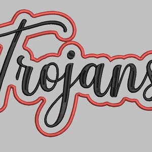 May include: The word "Trojans" in a black script font with a red outline. The text is on a gray background. The design is likely for apparel or team merchandise.