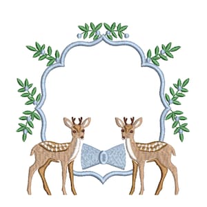 May include: An embroidered design featuring two deer facing each other, framed by a light blue arch with green foliage. A light blue bow is centered below the deer. The deer are brown with white spots.