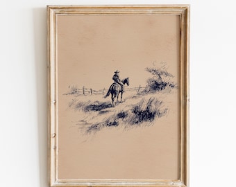 May include: Framed vintage print of a cowboy riding a horse. The artwork is a pen and ink drawing in shades of brown and navy blue. The cowboy is wearing a hat and riding away from the viewer. The print is in a gold-colored frame.