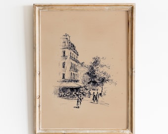 May include: Framed black and white sketch of a European street scene. The artwork depicts a building with a cafe, people walking, and a tree. The frame is a light brown color.