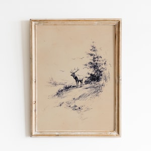 May include: A framed vintage-style print featuring a detailed pen and ink drawing of an elk standing on a hillside. The artwork is in shades of black and white, with a light brown background. The frame is a light wood color.