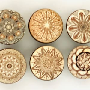 May include: Six round wooden coasters with intricate laser-cut mandala designs in shades of brown and beige.