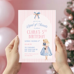 May include: A rectangular birthday invitation card with a light pink and white vertical striped background. It features a blue bow at the top, an arched white center, and text reading: Join us in the Land of Sweets to celebrate CLARA'S 5TH BIRTHDAY.