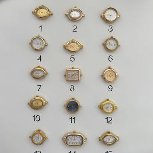 May include: Fifteen small, gold-toned vintage watch faces with various shapes and designs. The faces include round, oval, and rectangular shapes, with white or gold dials and Roman numeral or stick hour markers.