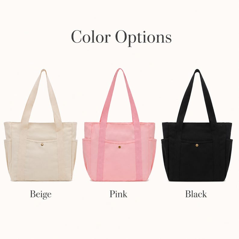 May include: Three tote bags in beige, pink, and black. Each bag has two side pockets, a front pocket with a gold button, and matching handles. The text "Color Options" is above the bags, with the color names below.