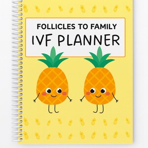 May include: A spiral-bound planner with a yellow cover featuring the text "FOLLICLES TO FAMILY IVF PLANNER." Two cartoon pineapples with smiling faces and arms are on the cover. The background is yellow with small pineapple illustrations.