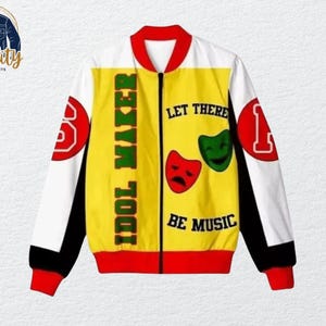 May include: A white, yellow, and red bomber jacket with the text "IDOL MAKER" and "LET THERE BE MUSIC". The jacket has red cuffs and collar, with the number "1" and "3" on the sleeves. The jacket features a zipper closure.
