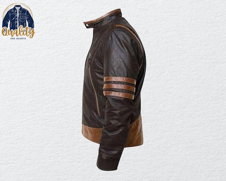 May include: A brown leather jacket with a stand-up collar and a zipper closure. The jacket features brown stripes on the sleeves and a brown trim at the bottom. The logo "Quality One Jackets" is in the upper left corner.