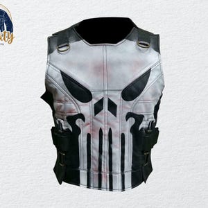 May include: A white and black leather vest featuring a skull design on the front. The vest has black accents, straps, and pockets. The vest is a sleeveless garment with a high collar and is likely a costume or cosplay item.